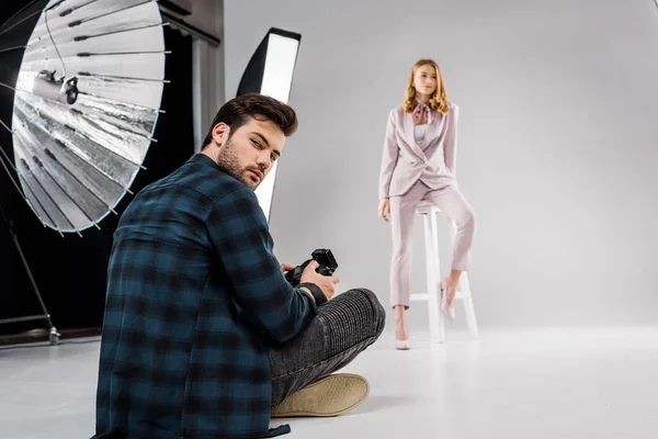 Photographer Sitting Looking Camera While Beautiful Female Model Posing Studio — Free Stock Photo