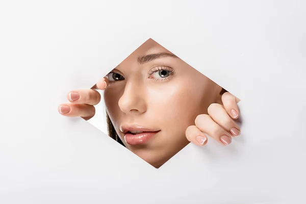 Beautiful Young Woman Peering Camera Hole White — Stock Photo, Image