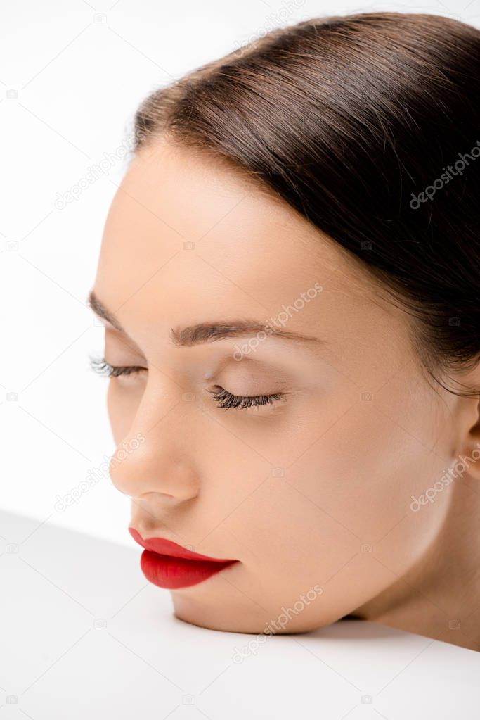 close-up view of beautiful young woman with closed eyes isolated on white 