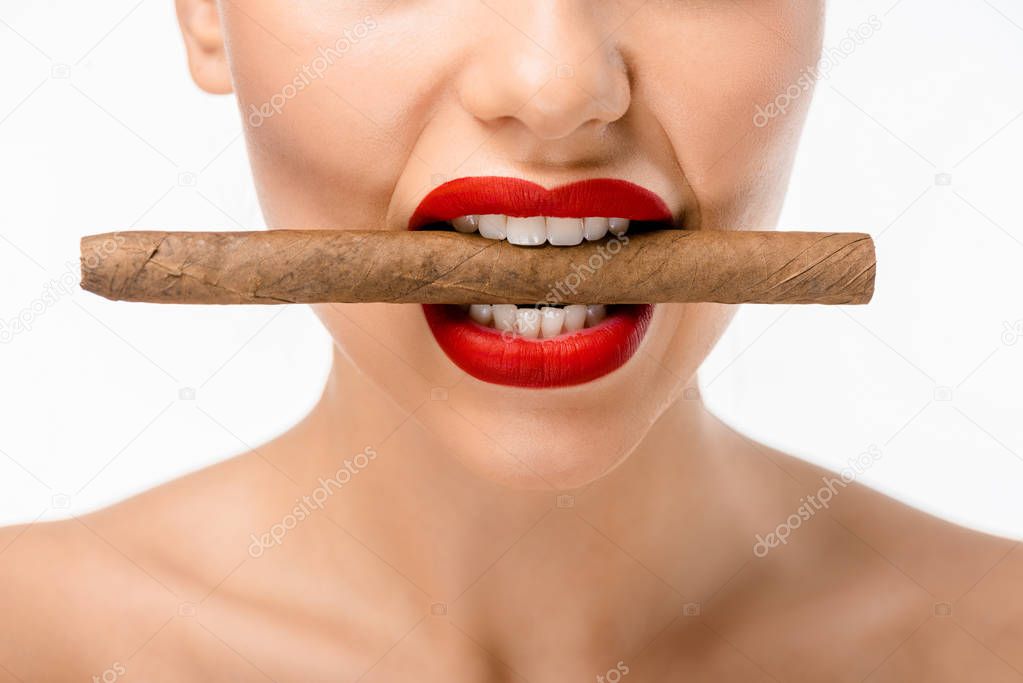 cropped shot of naked girl holding cigar in mouth isolated on white