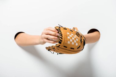 cropped image of sportswoman holding baseball glove and ball through holes on white clipart