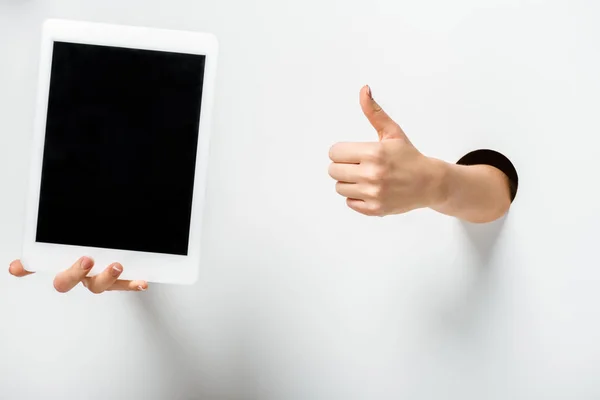 Cropped Image Woman Holding Tablet Blank Screen Holes Showing Thumb — Stock Photo, Image