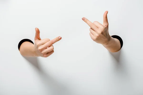 Cropped Image Woman Showing Middle Fingers Holes White — Stock Photo, Image