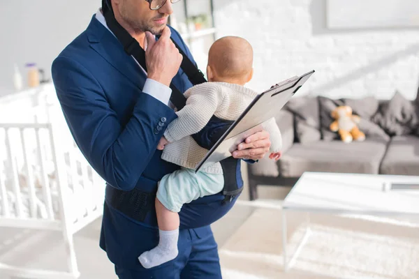 Cropped View Pensive Businessman Suit Holding Clipboard Infant Daughter Baby — Stock Photo, Image