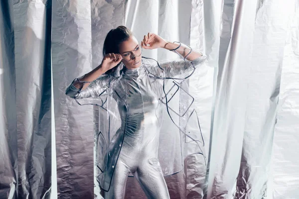 Elegante Joven Posando Traje Cuerpo Plateado Impermeable Sobre Fondo Metálico —  Fotos de Stock