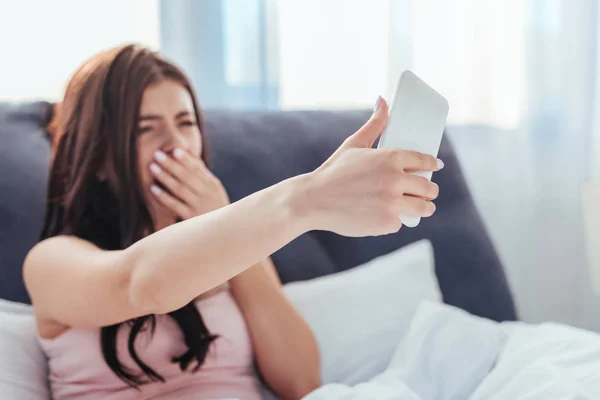 Gjespende Selfie Smarttelefon Mens Hun Sitter Sengen Morgenen Hjemme – royaltyfritt gratis stockfoto