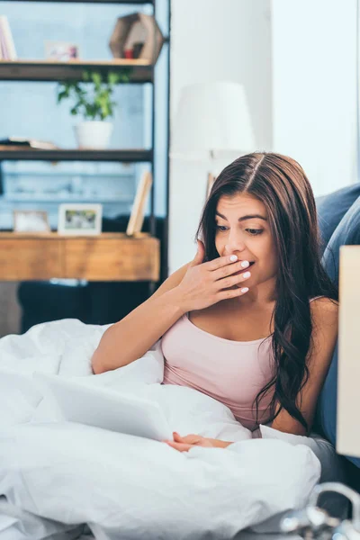 Surprised Young Woman Covering Mouth Hand Using Digital Tablet Bed — Free Stock Photo