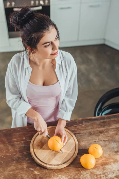 High Angle View Attractive Girl Cutting Orange Knife Wooden Board — Free Stock Photo