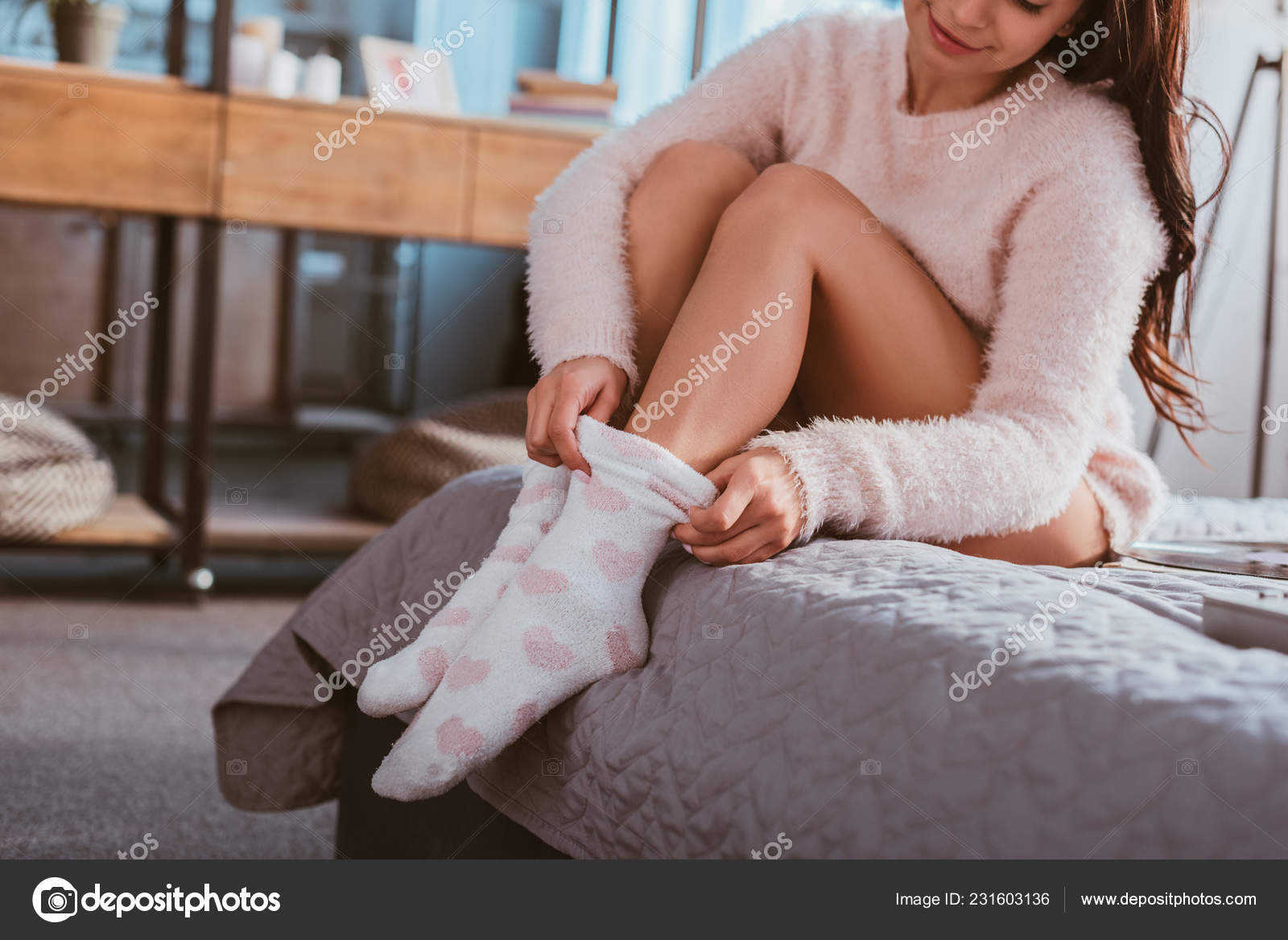 Partial View Girl Putting Fluffy Socks While Sitting Bed Home