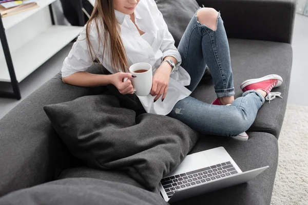 Partial View Girl Holding Coffee Cup Sitting Couch Laptop Living — Stock Photo, Image
