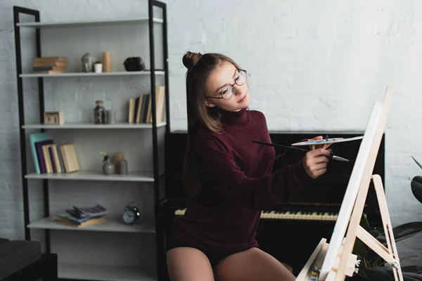 Piękna Dziewczyna Bordowy Sweter Siedzi Malarstwo Płótnie Domu — Zdjęcie stockowe