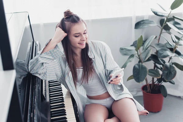 Sexy Girl Shirt Underwear Smiling Sitting Piano Using Smartphone Home — Stock Photo, Image