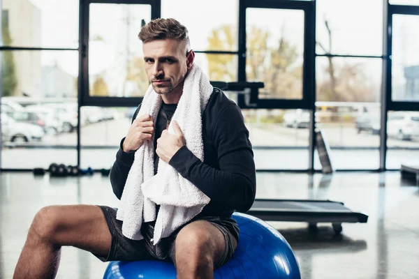 Handsome Sportsman Sitting Fitness Ball Towel Looking Camera Gym — Stock Photo, Image