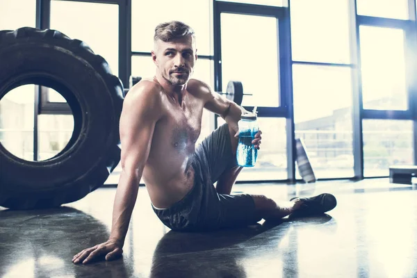 Handsome Shirtless Sportsman Sitting Floor Gym Holding Sport Bottle — Stock Photo, Image