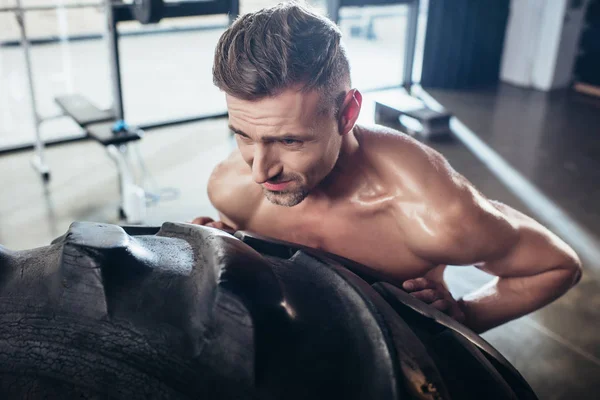 High Angle View Handsome Sweaty Shirtless Sportsman Lifting Tire Gym — Free Stock Photo