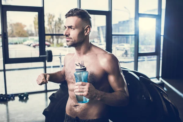 Handsome Muscular Sportsman Leaning Tire Holding Sport Bottle Gym — Free Stock Photo