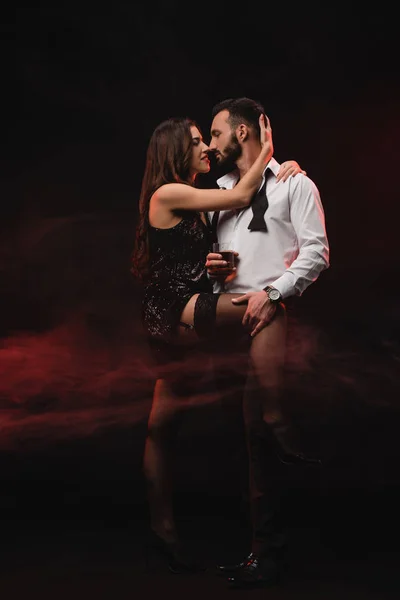 Passionate Woman Hugging Man Glass Whiskey Red Smoky Room — Stock Photo, Image