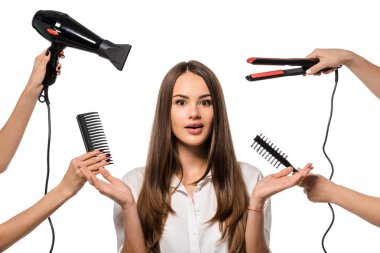 women holding accessories of hairdresser around surprised girl gesturing with hands isolated on white clipart