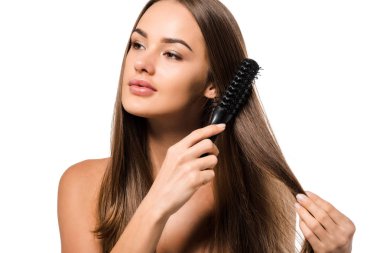 attractive girl combing long brown hair with hairbrush isolated on white clipart