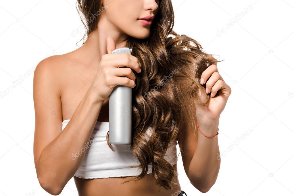 cropped view of girl with long brown hair holding spray bottle isolated on white