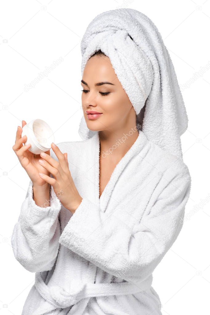 beautiful girl in bathrobe holding jar with cream isolated on white