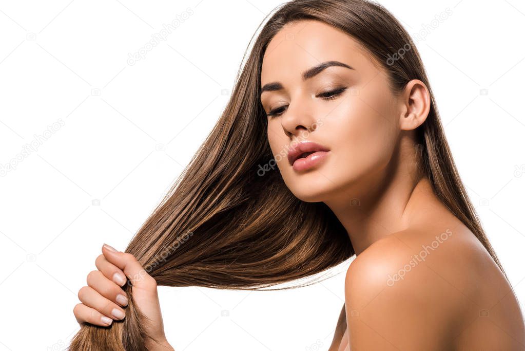 beautiful woman holding long brown hair isolated on white