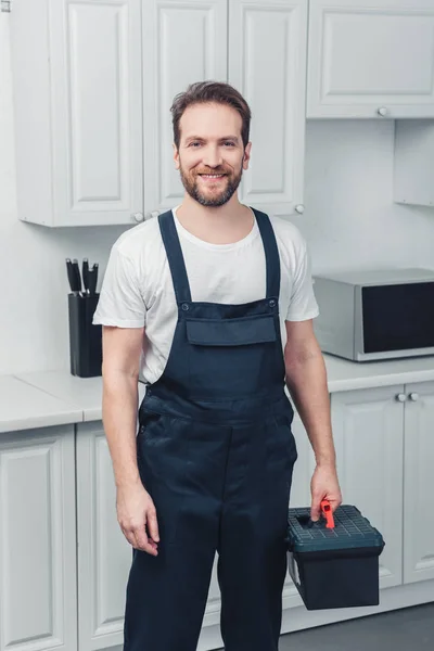 Adult Smiling Bearded Repairman Working Overall Holding Toolbox Kitchen Home — Stock Photo, Image