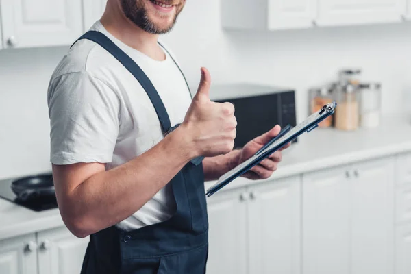 Partial View Handyman Holding Clipboard Doing Thumb Gesture Kitchen — Stock Photo, Image