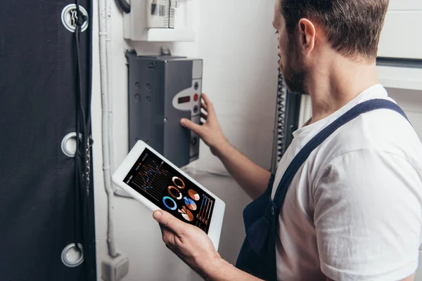 Male Electrician Holding Digital Tablet Graphs Screen Checking Electric Box — Stock Photo, Image