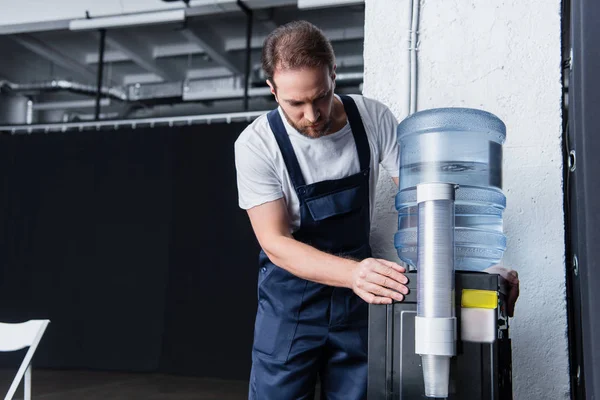 Serious Handyman Working Overall Checking Broken Water Cooler — Stock Photo, Image
