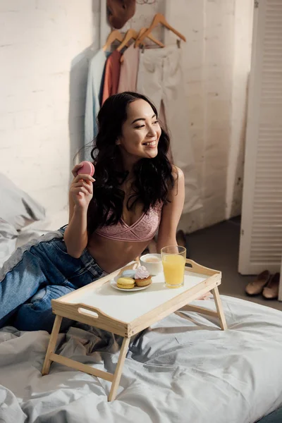 Smiling Young Asian Woman Having Breakfast Looking Away Bedroom — Stock Photo, Image