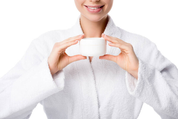 cropped view of woman in bathrobe holding face cream isolated on white