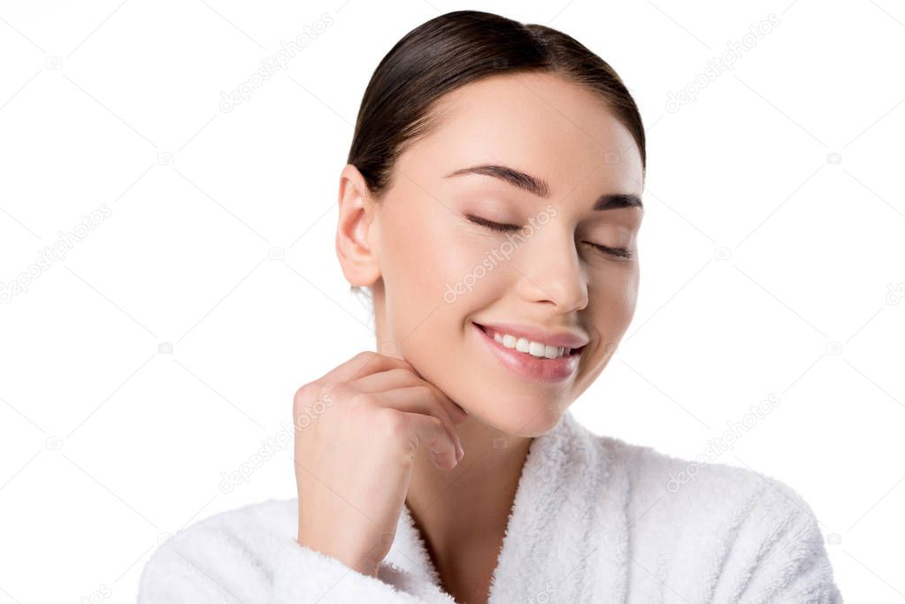 beautiful woman in bathrobe with eyes closed touching face isolated on white