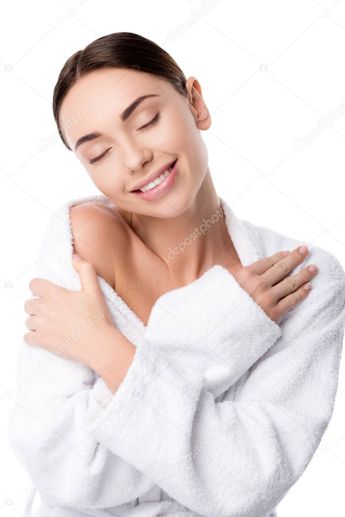 beautiful smiling woman in bathrobe with crossed hands and eyes closed isolated on white