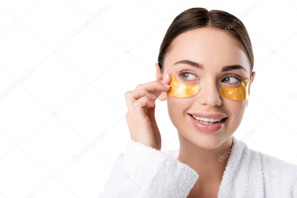 beautiful smiling woman with golden eye patches touching face isolated on white