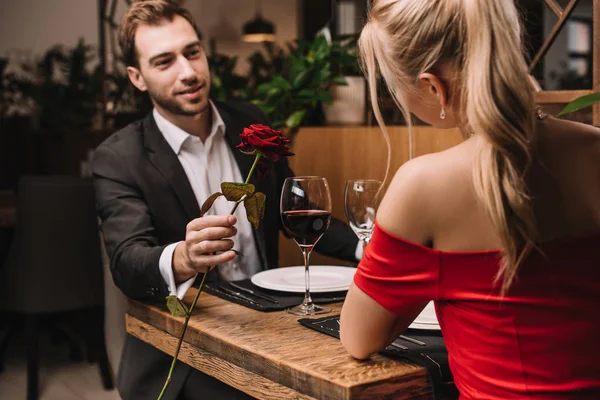 Cheerful Man Giving Red Rose Girlfriend While Sitting Restaurant — Stock Photo, Image
