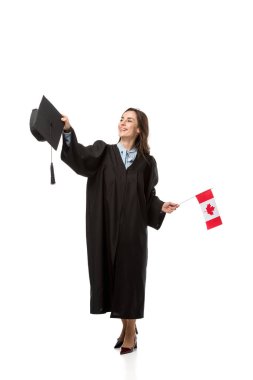 female student in academic gown holding canadian flag and mortarboard isolated on white clipart