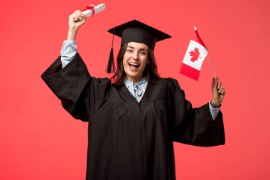 female student in academic gown holding canadian flag and diploma isolated on living coral clipart