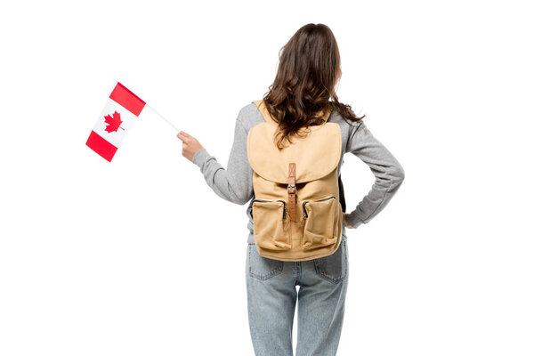 back view of female student with canadian flag and hand on hip isolated on white