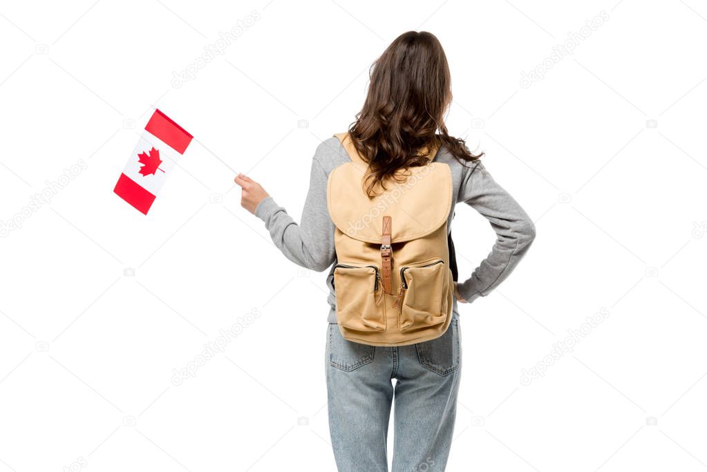 back view of female student with canadian flag and hand on hip isolated on white