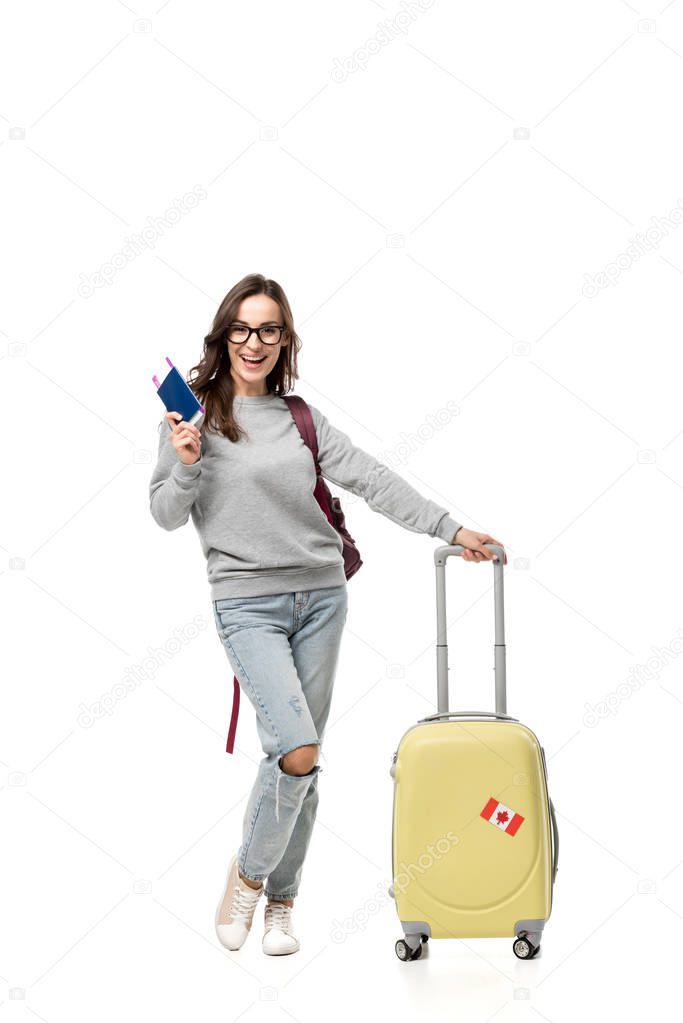 female student with suitcase holding passport and air tickets isolated on white, studying abroad concept