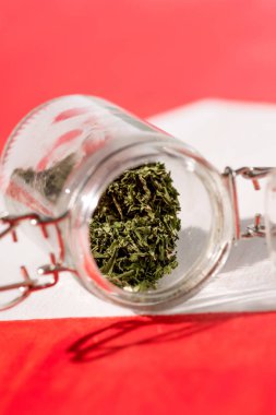 selective focus of cannabis in glass jar, marijuana legalization concept clipart
