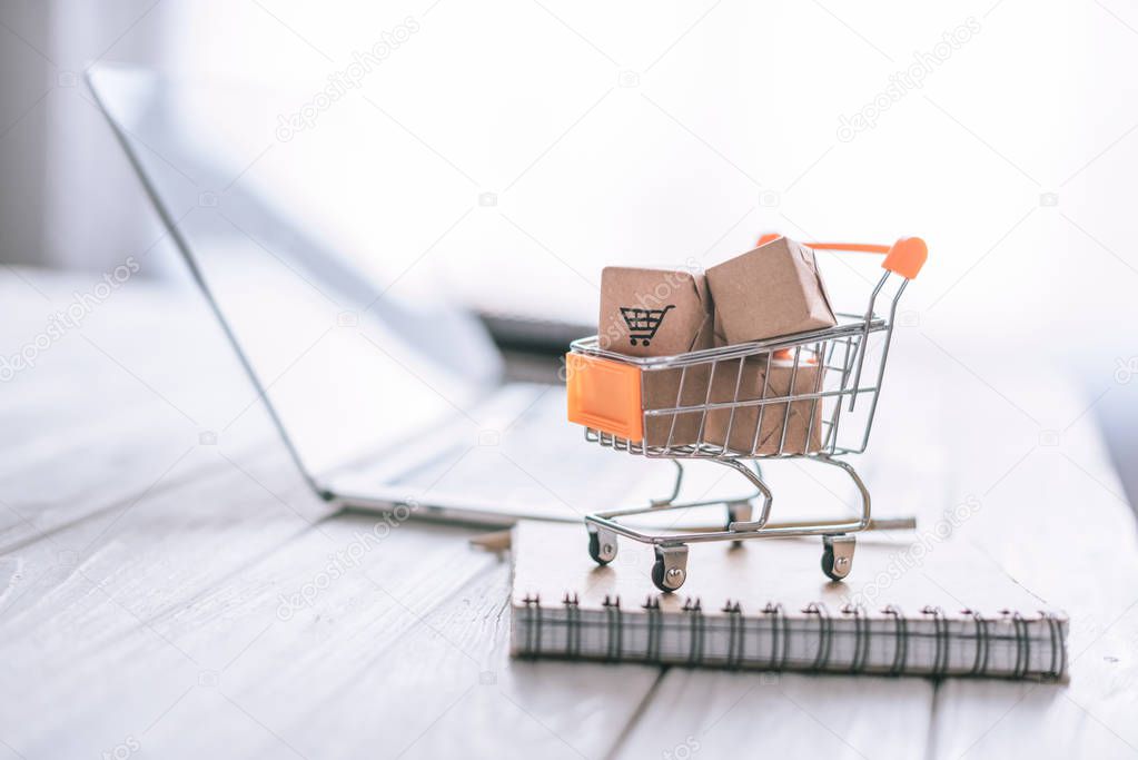 close up of packages in decorative cart on wooden desk