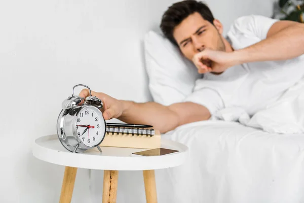 Selective Focus Yawning Man Waking Looking Alarm Clock — Stock Photo, Image