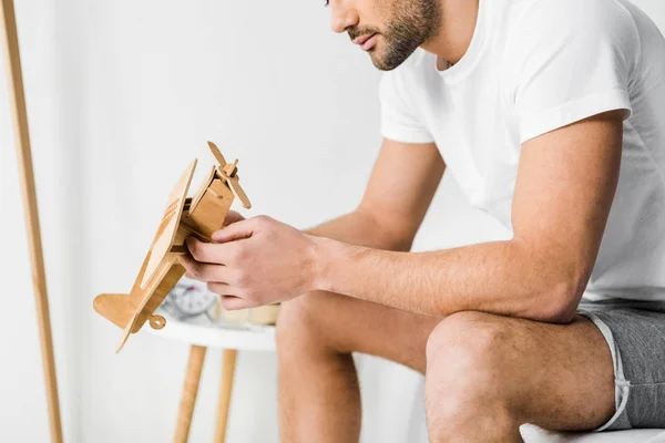 Cropped View Man Holding Wooden Toy Airplane Bedroom — Stock Photo, Image