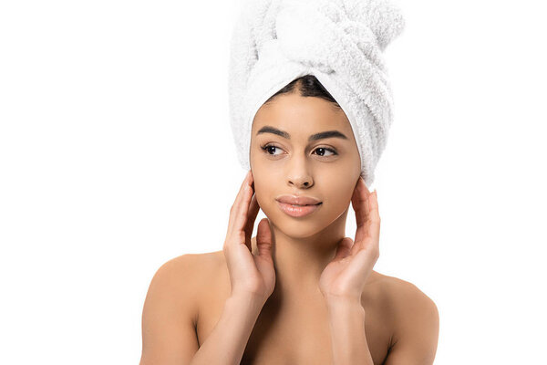 beautiful naked african american woman with towel on head looking away isolated on white