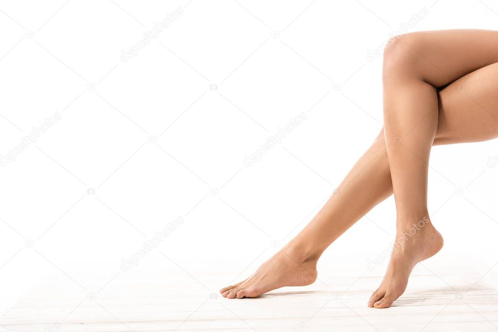 low section of beautiful slim smooth female legs on white 