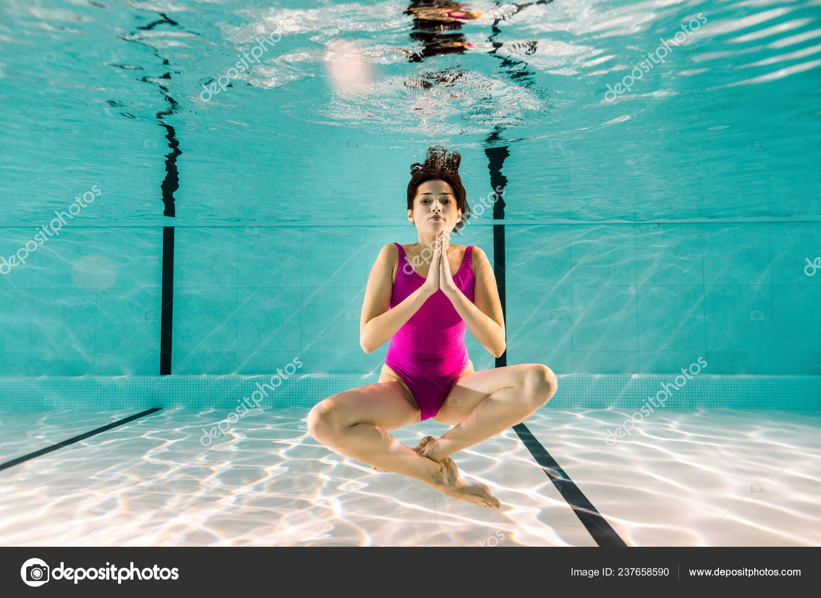 Premium Photo | Two young women doing yoga pose at the swimming pool