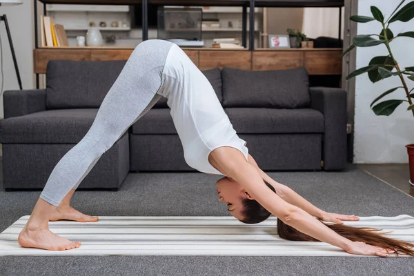 Young Woman Practicing Downward Facing Dog Pose Home — Stock Photo, Image