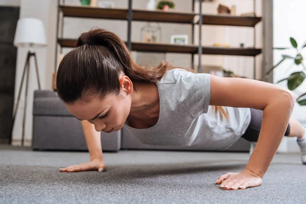 Selective Focus Concentrated Sportswoman Doing Push Ups Home — Stock Photo, Image